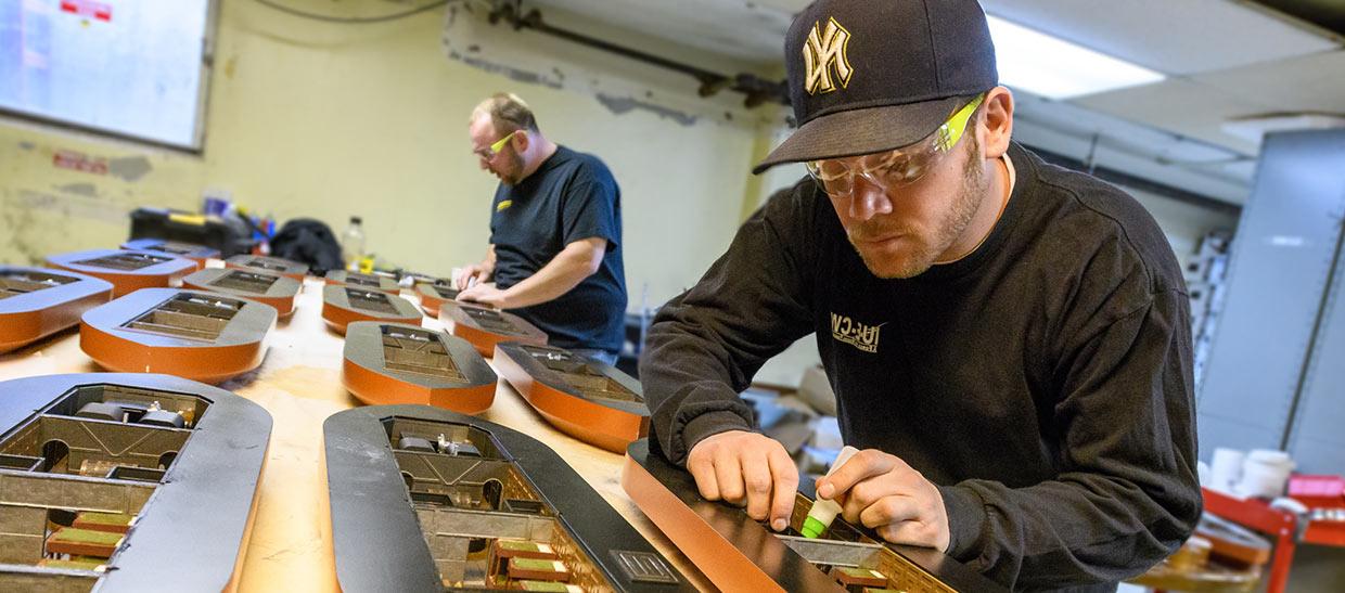 Manufacturing students building a model boat