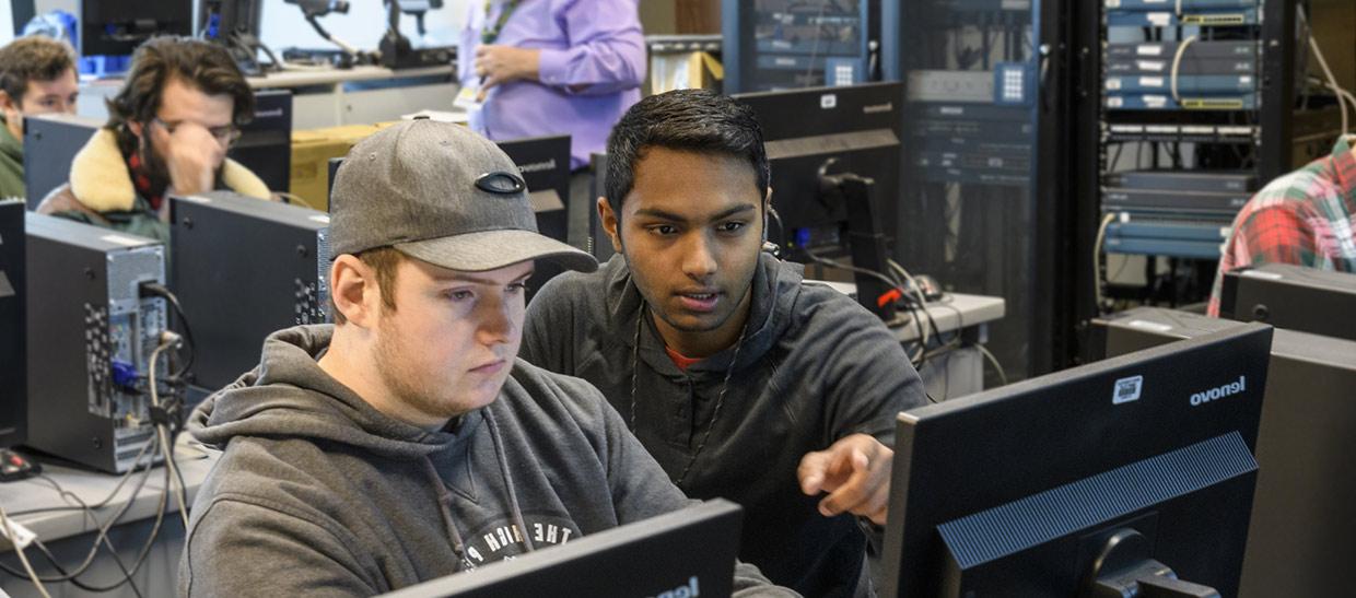 Students looking at a computer